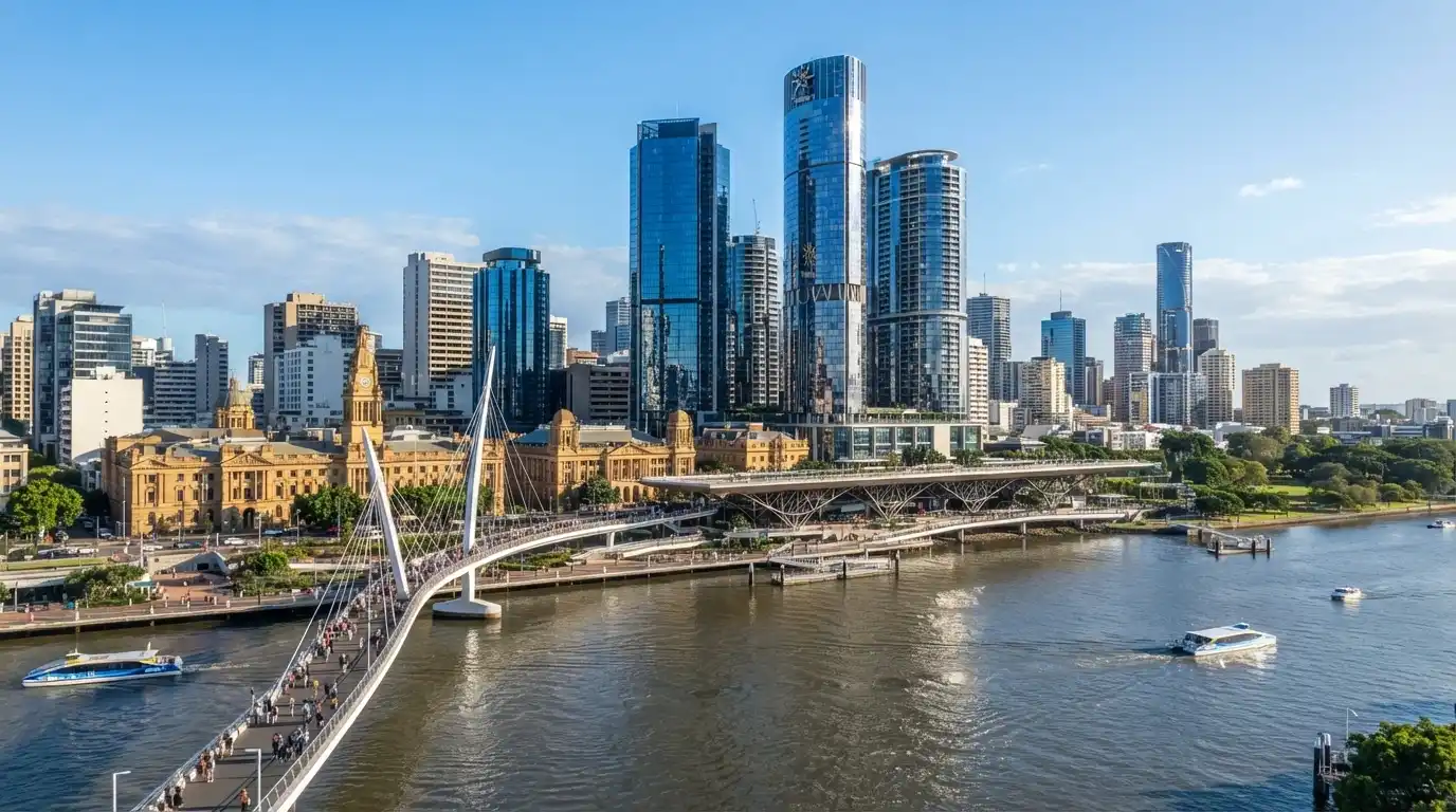 The full Queen's Wharf precinct viewed from South Bank, showing the Neville Bonner Bridge connection, the heritage buildings and the towers rising above the river